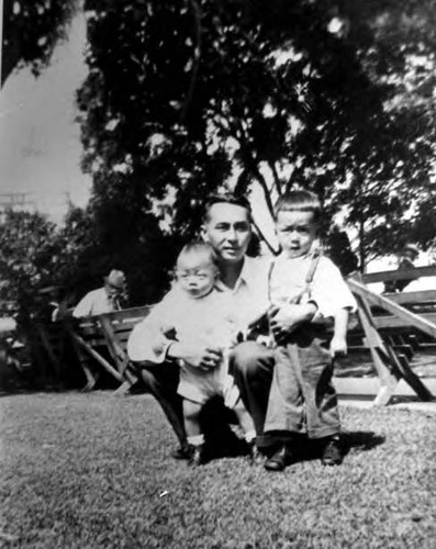 Man and two kids in a park