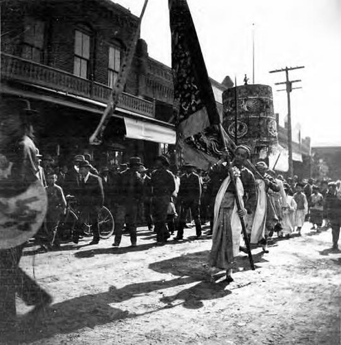 Chinese parade- corner of Plaza and L.A. Street in front of Jennette Building (shows firehouse as Montezuma Saloon)