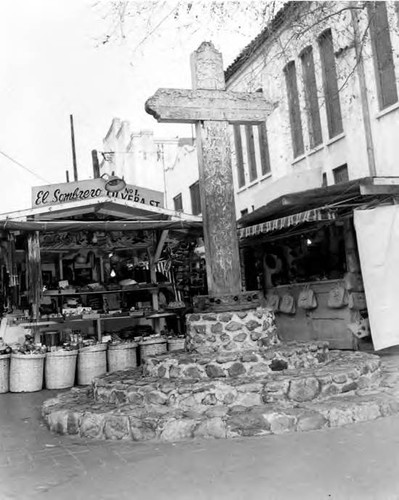 Headon view of Olvera Street Cross with surrounding booths