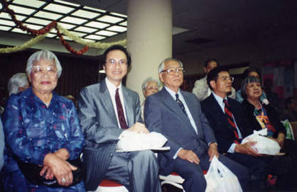 Lily Chan, president of the CCOA, awarding Wilbur Woo, a representative from Cathay Bank, who donated $10,000 to the CCOA Nutrition Department. The money came from the proceeds of a Golf Tournament. Wilbur Woo is in the middle and Lily Chan is on the right