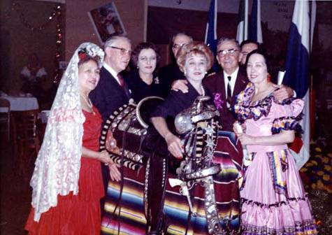 Presentation Party, Princess Conchita Pignatelli (center), Consuelo Bonzo (left) and Eugene Biscailuz (right), and Sheriff Zmeritus with his silver mounted saddle he in rode in traditional parades to be displayed witha Italian antique bed-room set, from Braut Rancho, donated by David O. Braut (not shown), for the Pres-Bridal Suite of the old Pico House when recronstructed on the Plaza