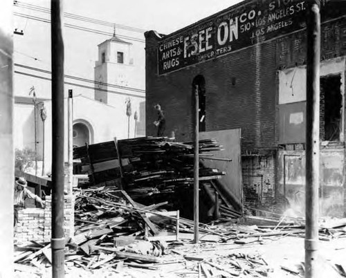 Closeup of lumber behind "F. See On Co." with Union Station in background