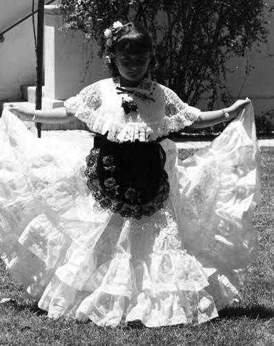 Photograph taken of a litter girl in her long dress on Flower and Camera Day