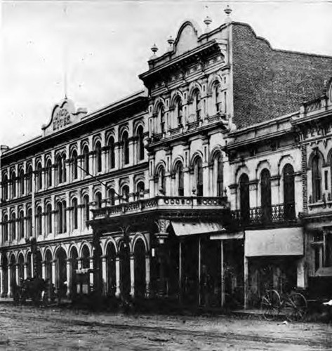 Pico House, Merced Theater and Masonic Lodge along Main Street with horse and buggy out front and a telegraph sign located on the first floor of the Pico House