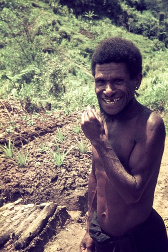 An older village leader, garden in background