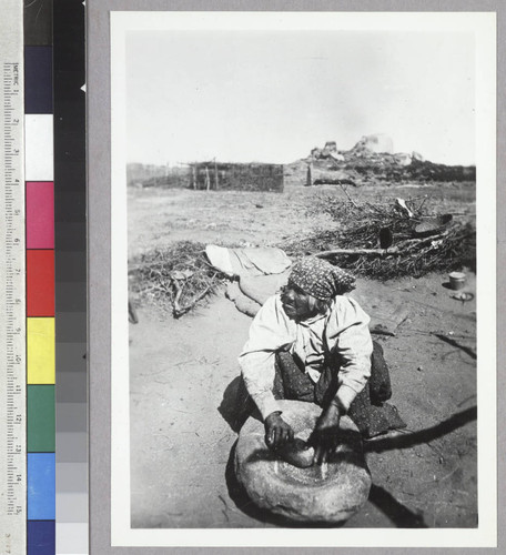 Cahuilla Indian woman grinding corn in stone mortar, ca. 1897