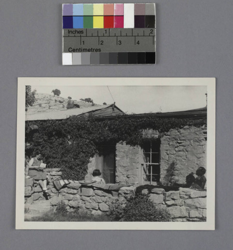 Grace Burke Hubble and Edwin Powell Hubble sitting in a patio outside a stone house in Shonto, Arizona, 1937