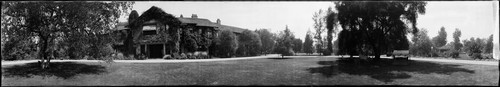 Mansion with a wide lawn and driveway