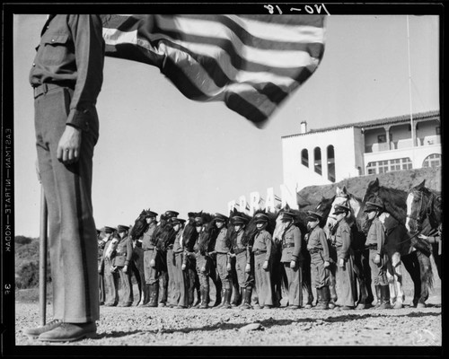 Boys standing with horses and American flag, Urban Military Academy, Brentwood, Los Angeles