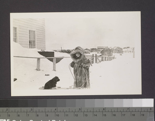 Child with puppy and sled