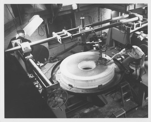 Robert Stiles polishing the Palomar 60-inch quartz disk at Hale Observatories' Pasadena machine shop