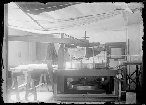 60-inch mirror being placed onto grinding machine