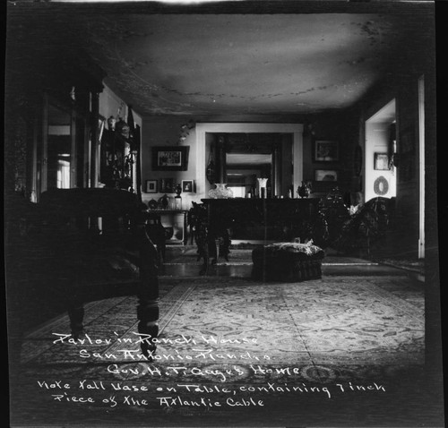 Parlor in Ranch House, San Antonio Rancho, Gov. H.T. Gage's home. Note tall vase on table, containing 7 inch piece of the Atlantic Cable