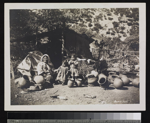 Papago Indian camp. Mother and two daughters, with pottery jars around them. Near Bisbee, Arizona