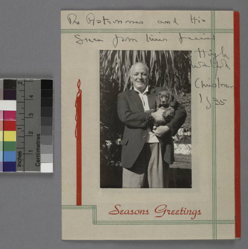 Photograph of Sir Hugh Seymour Walpole, and his dog, mounted on a Christmas card