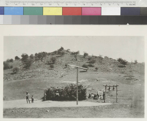 Mission Santa Ysabel, showing cross, bells and a brush hut