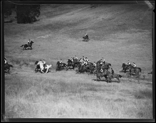 Santa Monica Lancerettes riding horses through a field