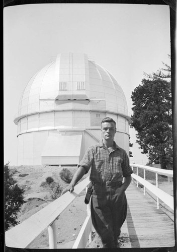 Victor B. Scheffer standing on the footbridge in front of the 100-inch telescope dome, Mount Wilson Observatory