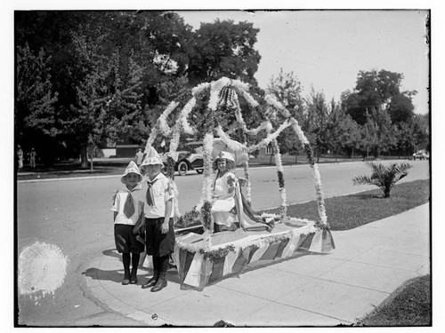 Small parade float with three children