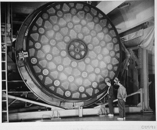 John A. Anderson and Marcus H. Brown inspecting the mirror for the 200-inch reflecting telescope