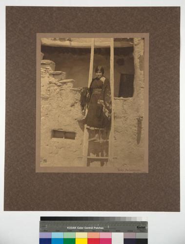 Walpi Architecture. Hopi Girl on Ladder