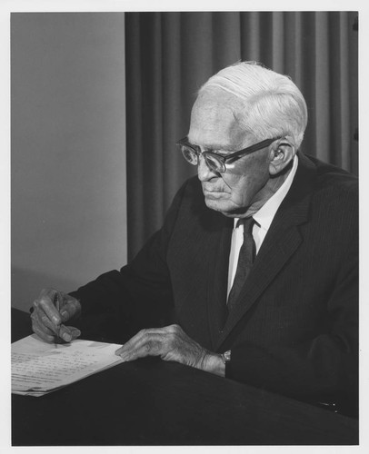 Alfred H. Joy, seated at his desk