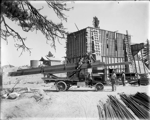 Truck loaded with 40-foot timbers at the construction site of the 100-inch telescope observatory, Mount Wilson Observatory