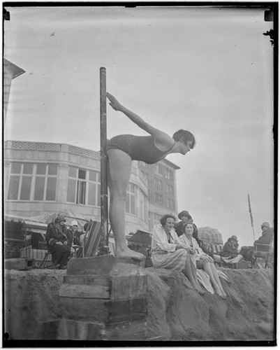 Swimmer in dive pose in front of Club Casa del Mar, Santa Monica, California