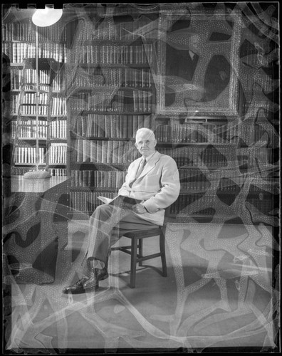 Roscoe F. Sanford, seated in the Hale Observatories Library, Pasadena