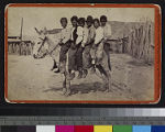 Yuma Indian boys sitting on a mule