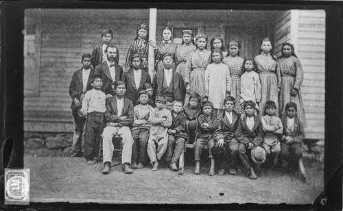 Modoc school children, girls and boys, with their white teacher, ca. 1875