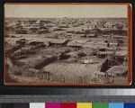 View of a Yuma Indian village in Arizona, showing adobe and brush dwellings