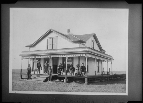 Home of Deacon Wind (Kiowa) of the Rainy Mt. church. Included in group are Deacon Sinco, Mrs. Sinco, Deacon Wind and family