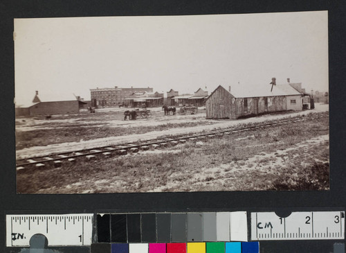 Railroad tracks going by a western town