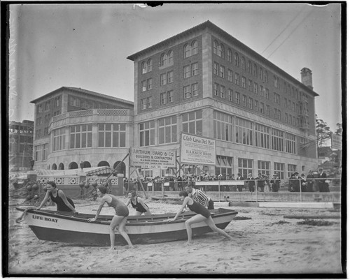 Swim team launching a lifeboat in front of Club Casa del Mar, Santa Monica, California