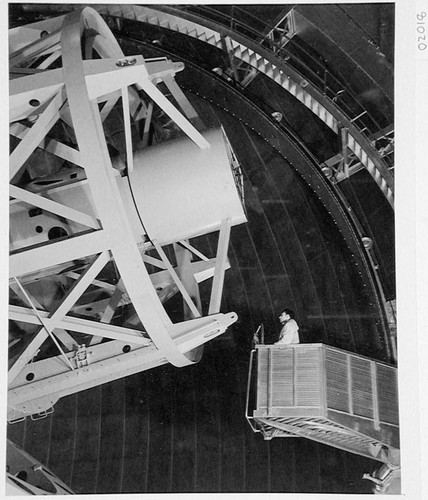 An observer riding the elevator to the prime focus cage of the 200-inch telescope, Palomar Observatory