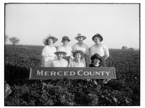 Seven women with a "Merced County" sign