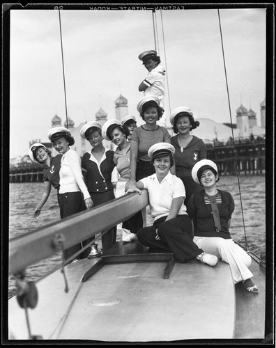 Young women on a boat at the Yacht Harbor Breakwater dedication, Santa Monica