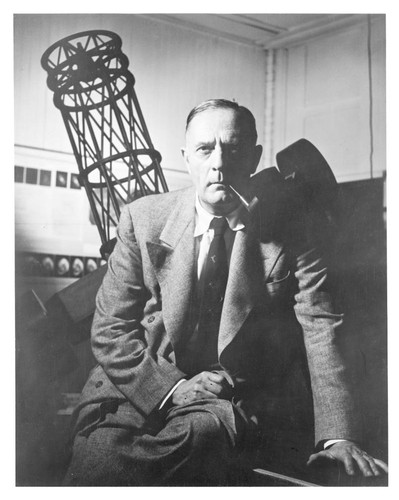 Edwin Powell Hubble, in front of a model of the 100-inch reflecting telescope