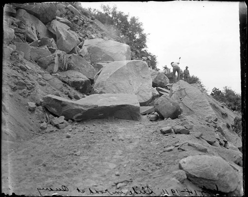 Construction workers breaking up rocks at a Mount Wilson rockslide