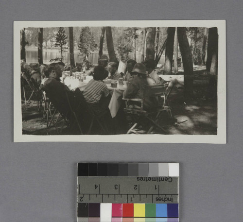 Edwin Powell Hubble and Grace Burke Hubble sitting at a table outdoors on a camping trip