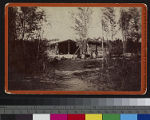 Yuma Indians sitting near a wood and brush dwelling, Arizona