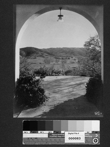 View of landscape through archway at Milflores, Spanish-style home of Harrison Gray Otis