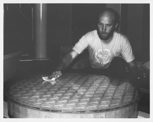 Thomas Gregory cleaning a large glass disk