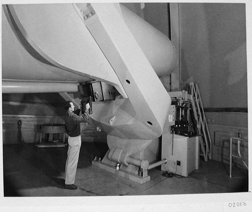 Chuck Kearns loading a plate into the plate holder on the 48-inch Schmidt camera, Palomar Observatory