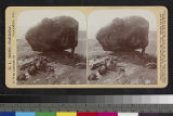 An unidentified man standing next to a boulder, Grand Canyon