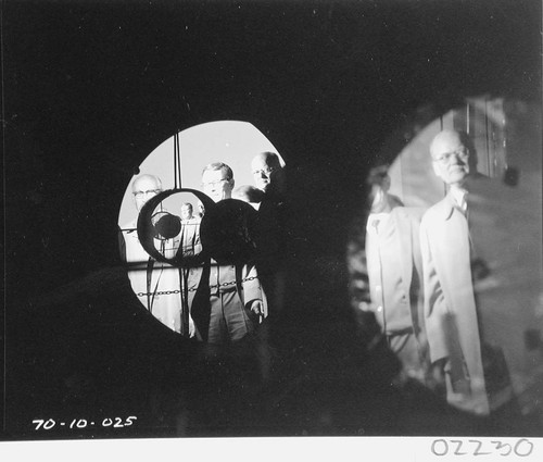 Arnold Beckman, Harold Brown and Caryl Haskins reflected in the mirror of the 60-inch telescope, Palomar Observatory