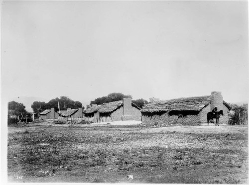 Part of the village of Palatingiva with a school house with an American flag