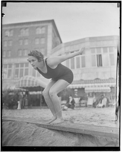 Swimmer in dive pose in front of Club Casa del Mar, Santa Monica, California