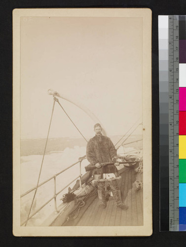 Unidentified ship. Man in furs with gun on deck